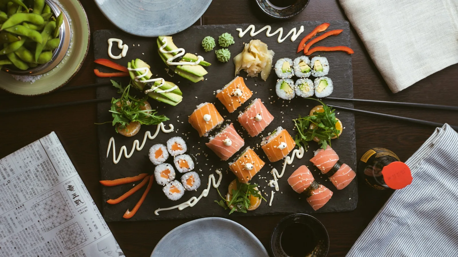 A composed plate of sushi on dark ceramic