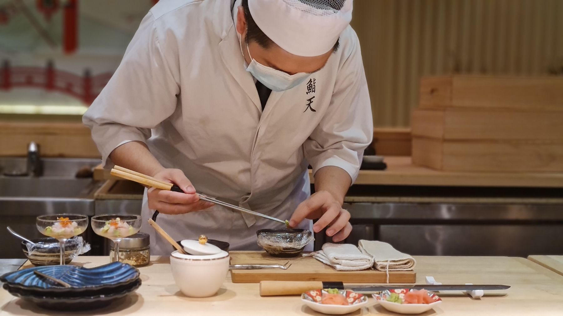 Chef concentrating while preparing sashimi at the counter