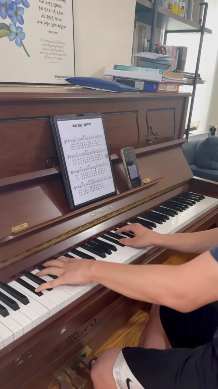 Woosung Lim playing piano at home during a worship session
